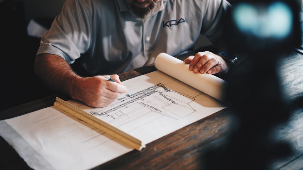 Man looking at house drawings