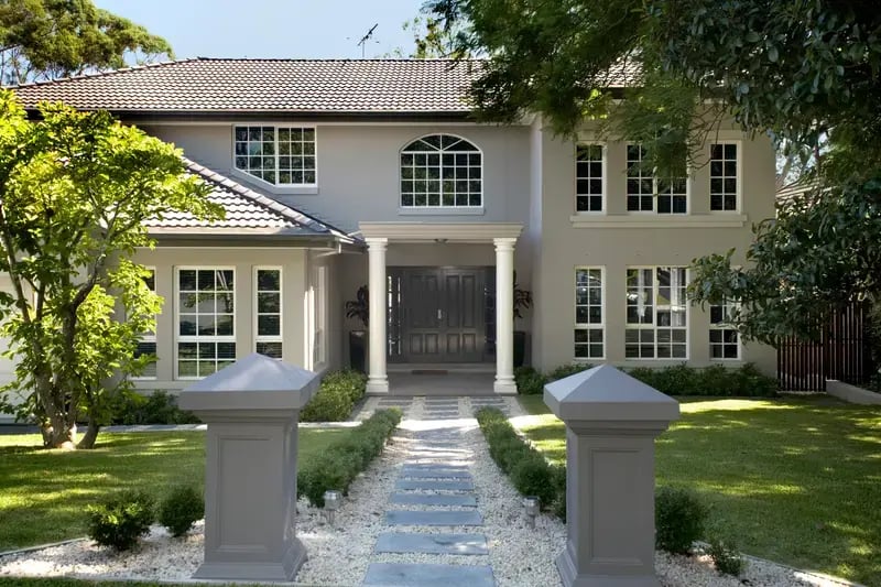 A two storey family home with a garden path to the front door
