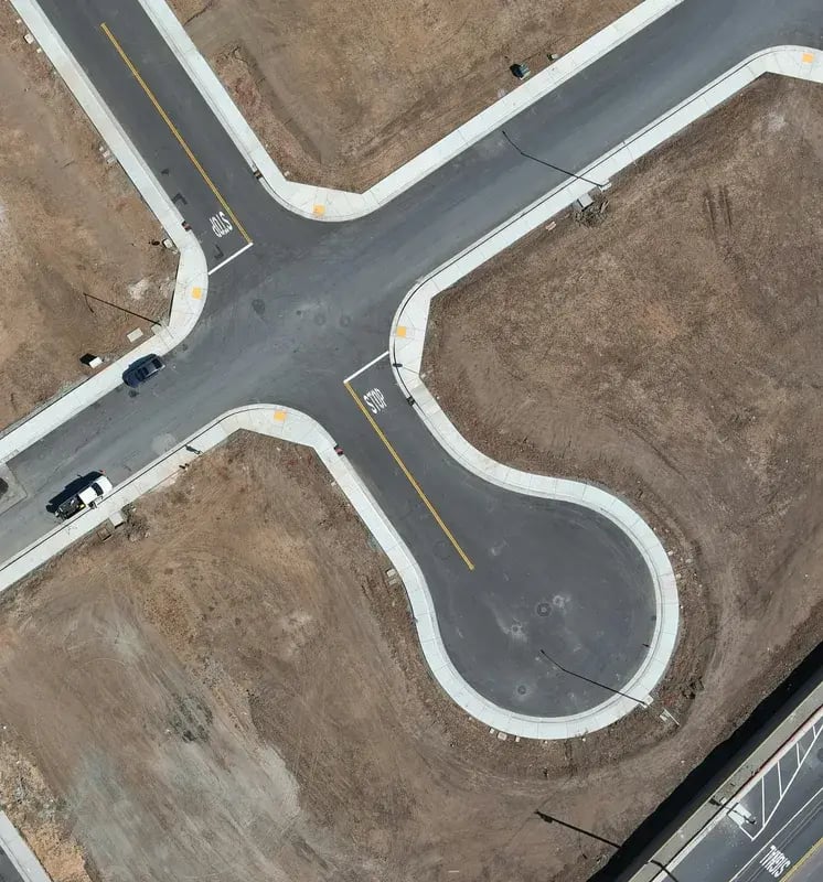 A graded subdivision site, its streets and cul-de-sac finished before any lot works begin