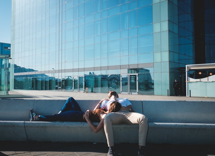 man and woman relaxing in city