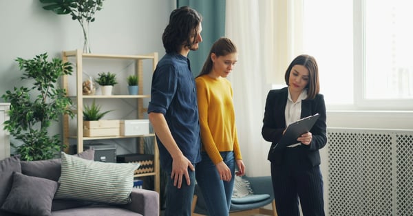 Couple asking a real estate agent questions during an inspection